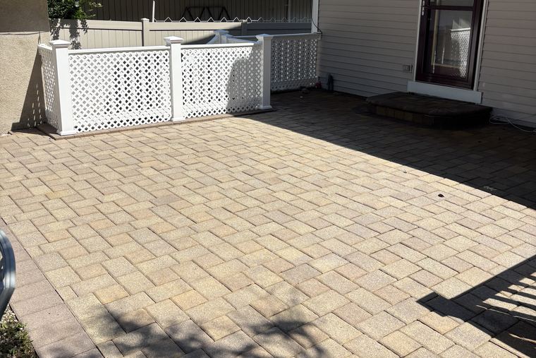 A freshly cleaned paver patio behind a Hamptons home