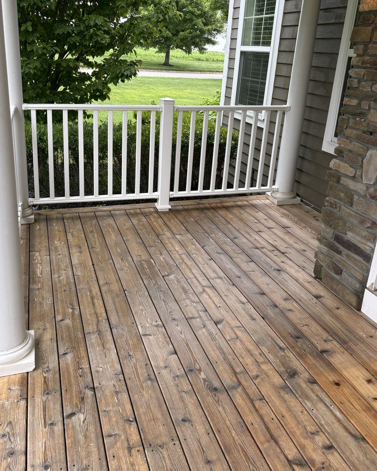 The same porch decking restored to warm brown after soft washing