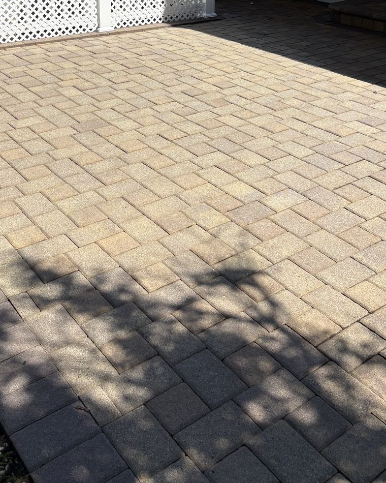The same paver patio cleaned back to its original sand colour